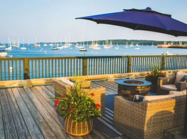 chairs around fire pit overlooking the water