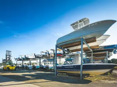 boats sitting outside on storage racks