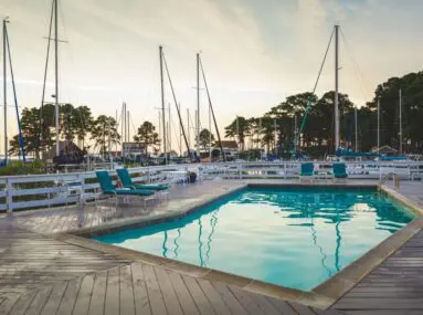 green chairs around a pool