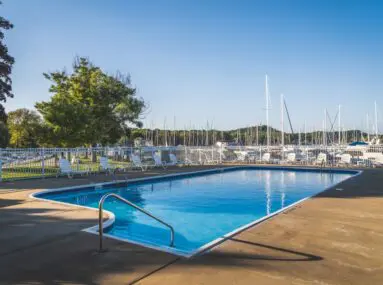 pool chairs around a pool on a sunny day