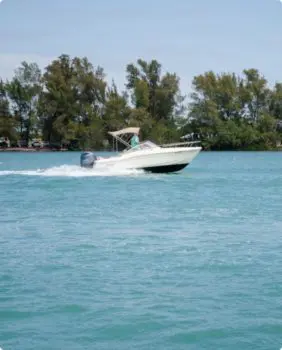boat driving fast on clear water