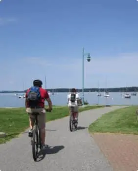 2 people biking on burlington boardwalk