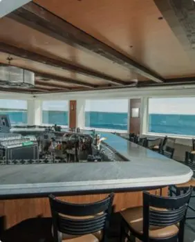 restaurant with bar inside and an ocean view