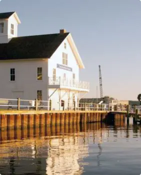white building next to a river