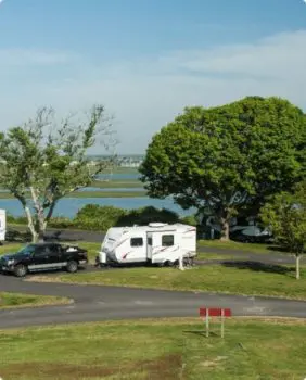 truck pulling rv behind it with trees in the background