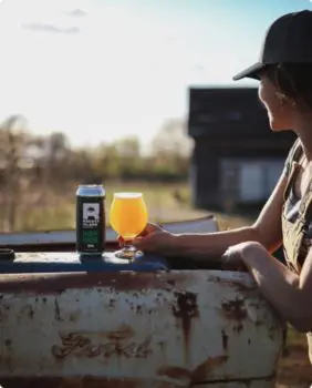 person holding a glass full of beer