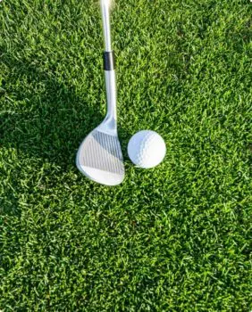 close up of golf club and golf ball