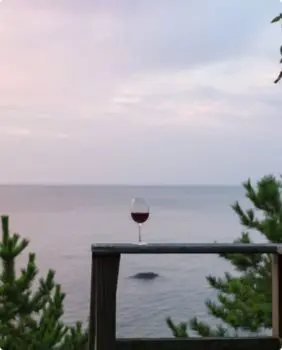 wine glass on a table overlooking water