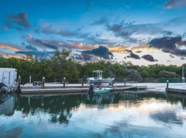 marina with one boat and clouds in the sky