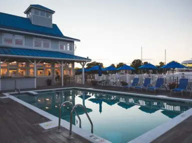 pool with chairs around it at dusk
