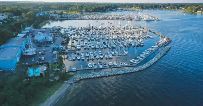 Drone shot of marina with many boats docked in the water