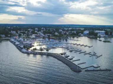 aerial view of marina with a few boats docked with cloudy sky