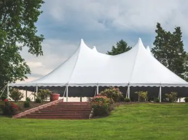 large white tent with a manicured lawn