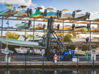 Boat in the process of being hoisted into an open-air storage