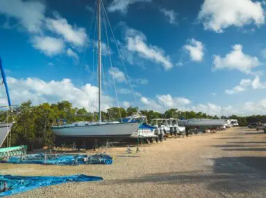 boats stored on dry land on gravel road