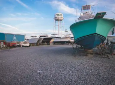 boats being stored with water tower in distance