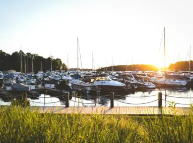 walkway with boats docked at marina