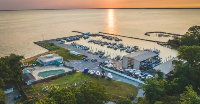 view of dry storage and slips on the water at sunset