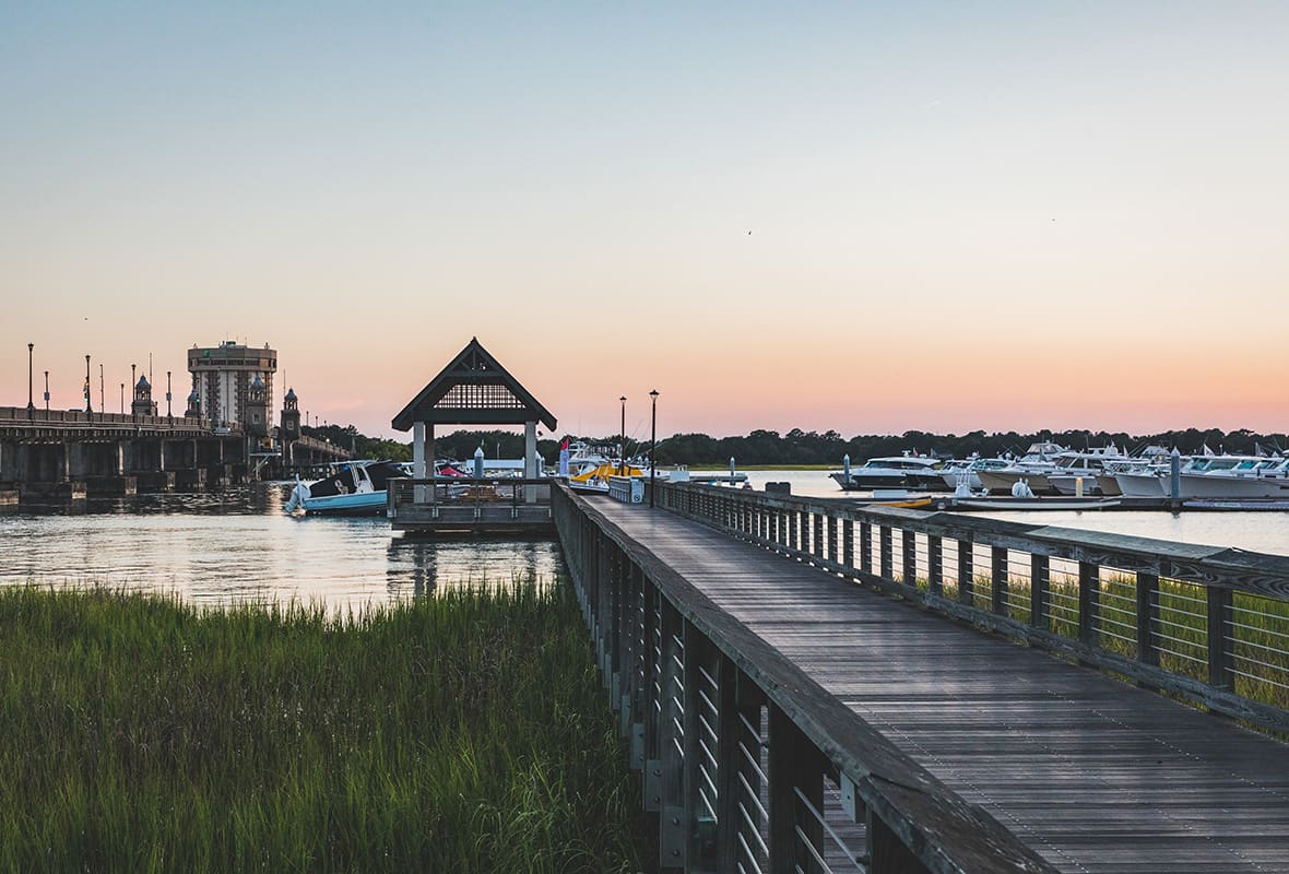Boats docked at marina at sunset