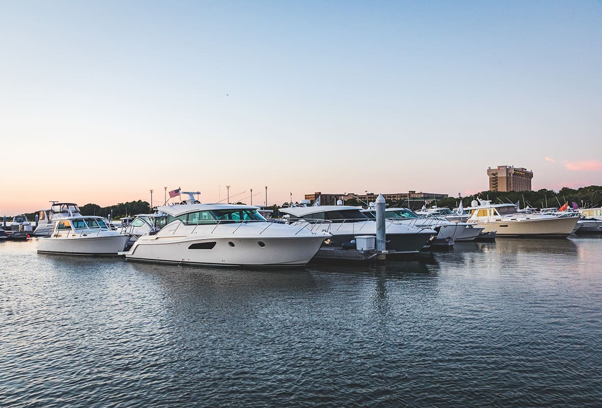 Boats docked at marina at sunset