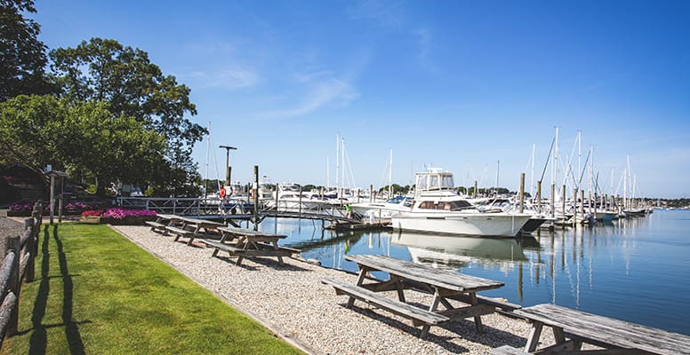 Picnic tables lining water
