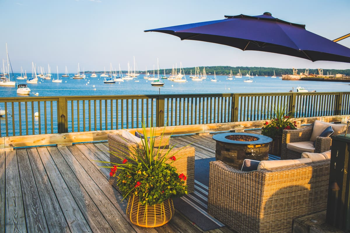 chairs around fire pit overlooking the water