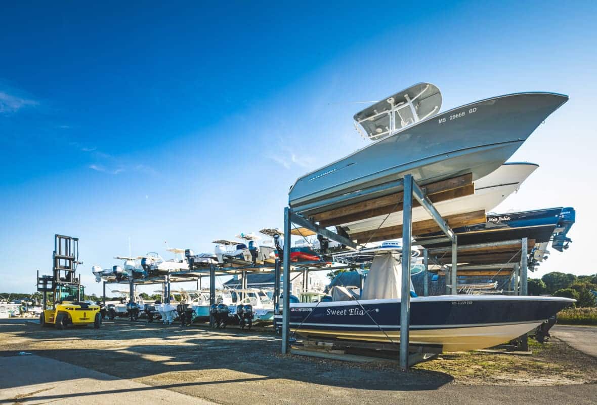 boats sitting outside on storage racks