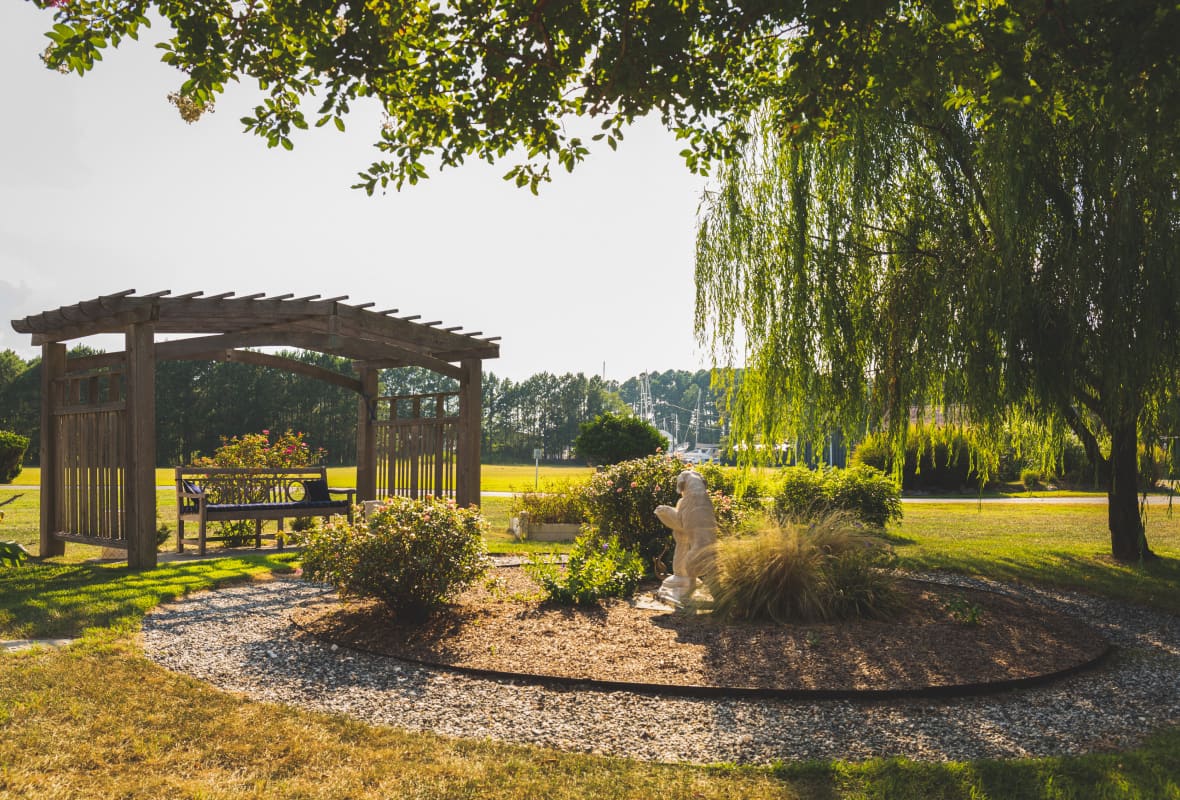 a gazebo with green trees next to it