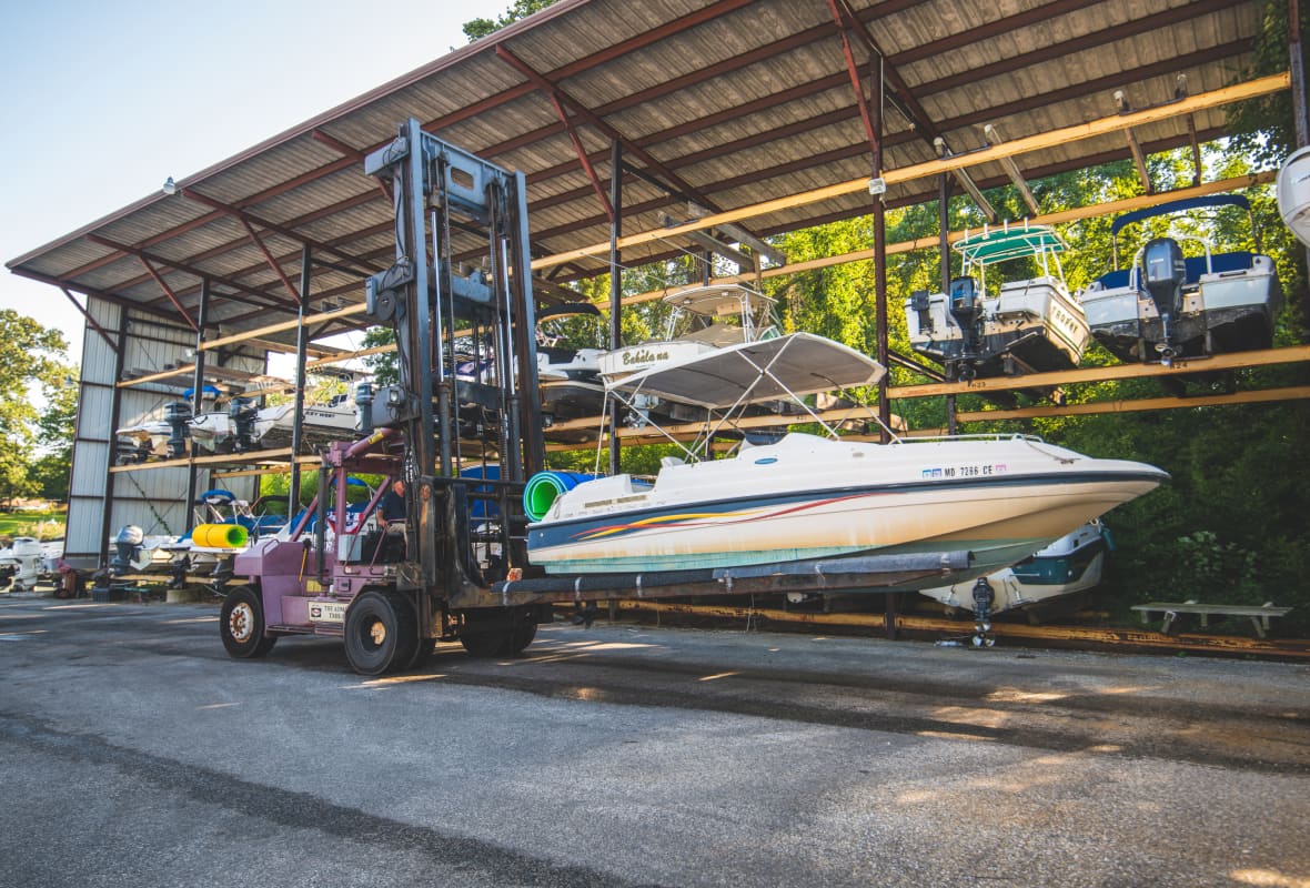 boat on a lift being moved to storage