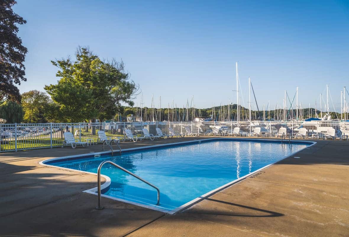 pool chairs around a pool on a sunny day
