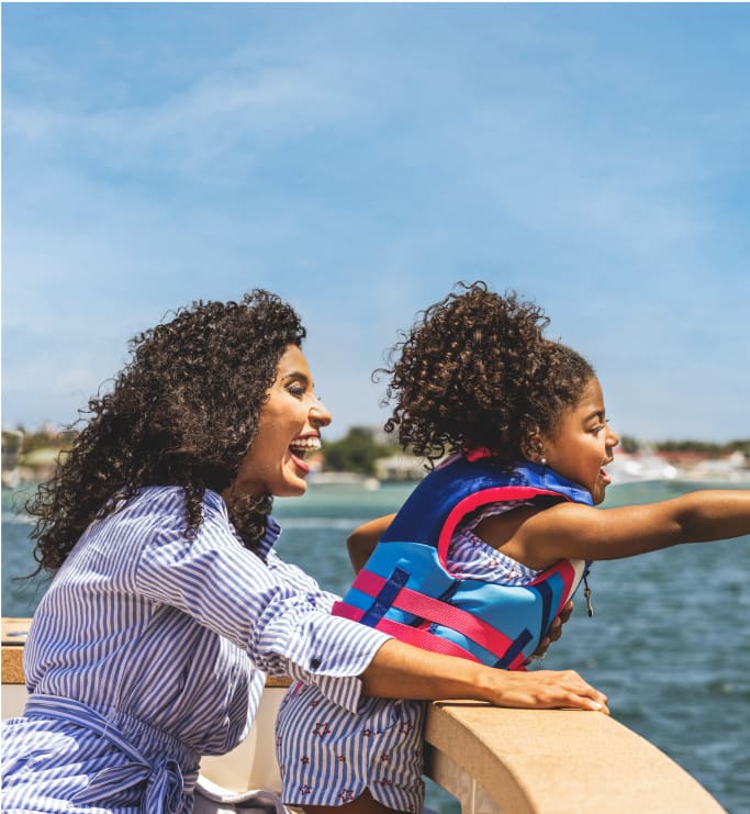 woman and little girl pointing to water