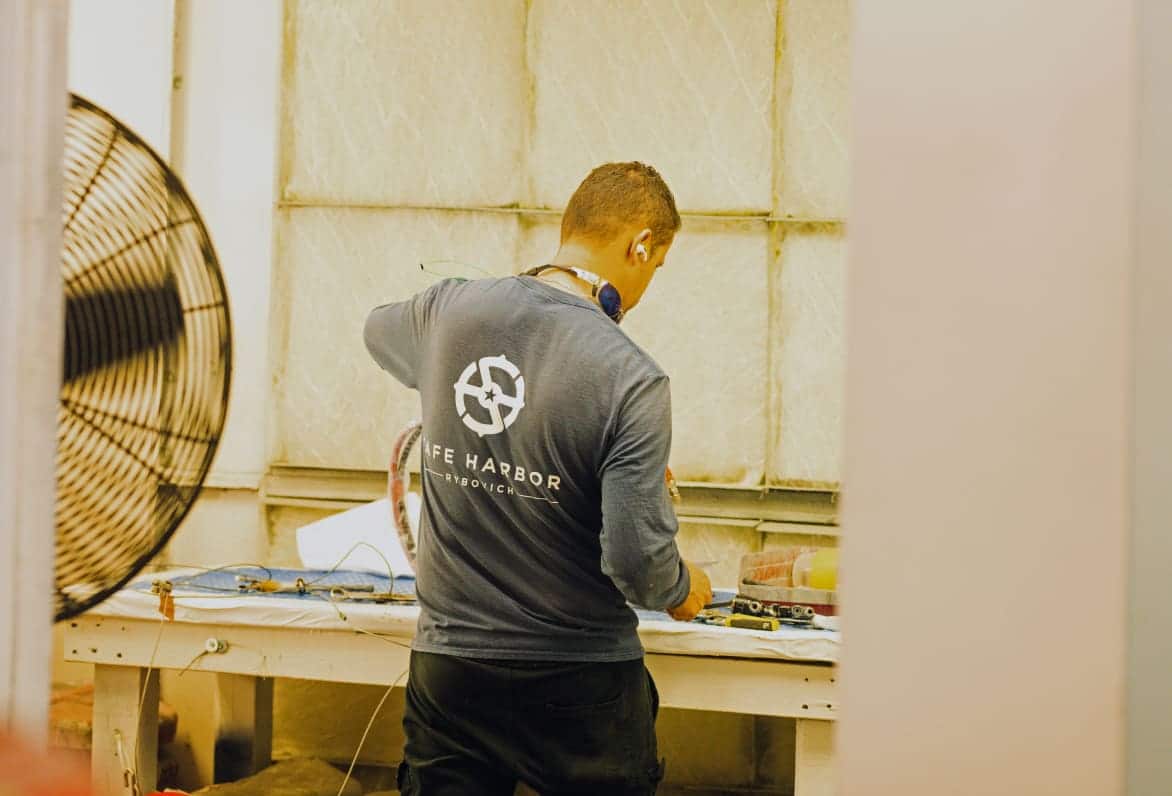 man working with yacht parts