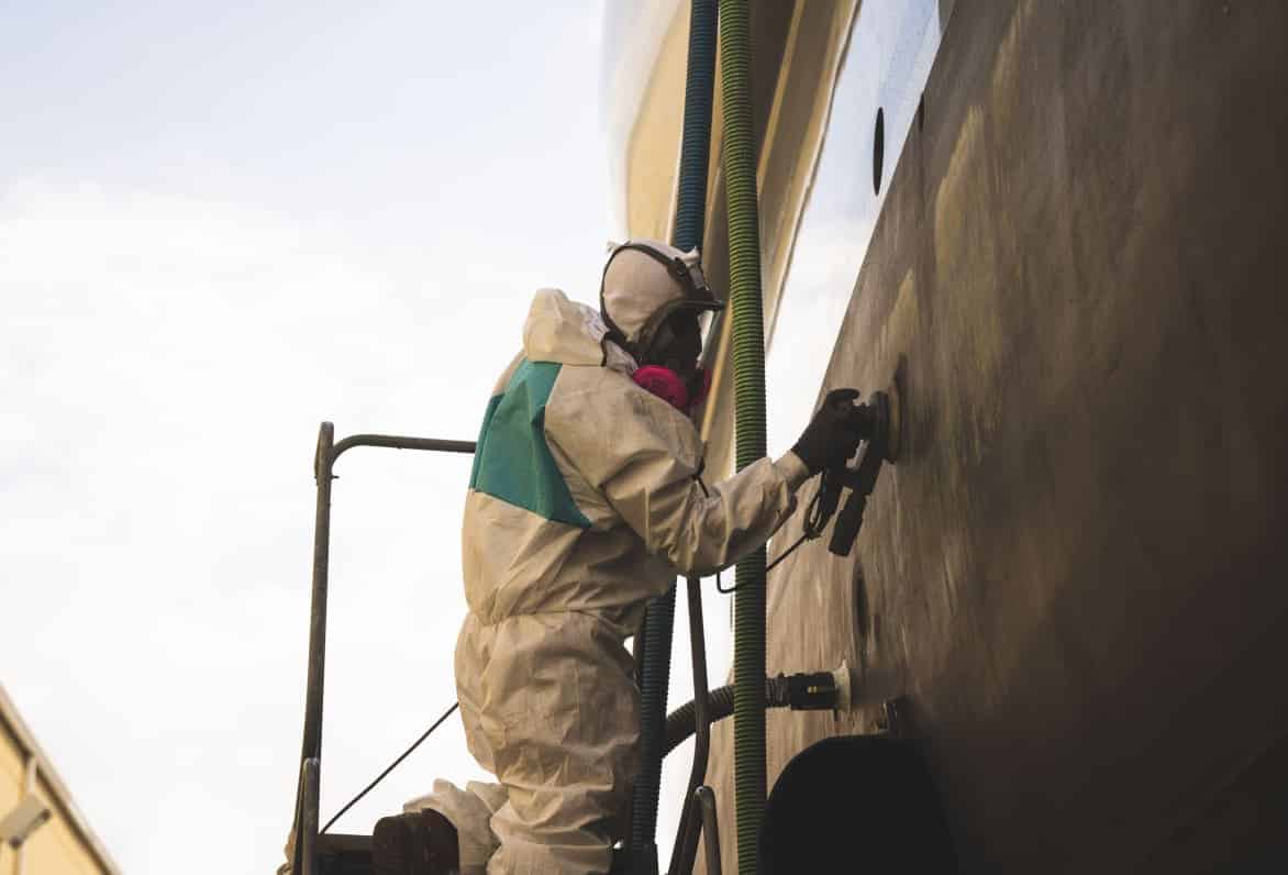 man buffing side of boat