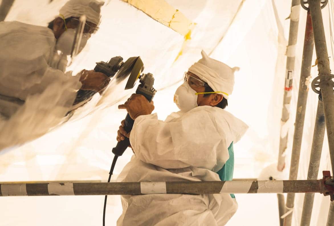 man buffing side of boat