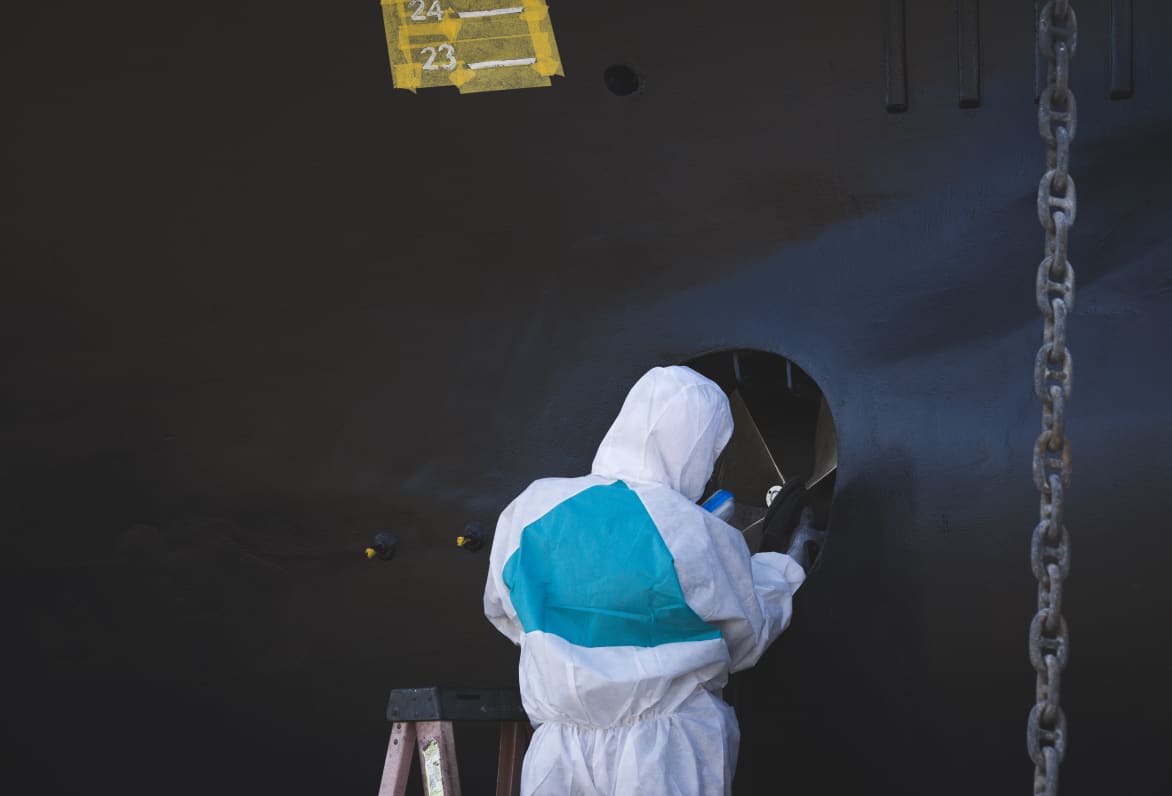 person servicing a yacht