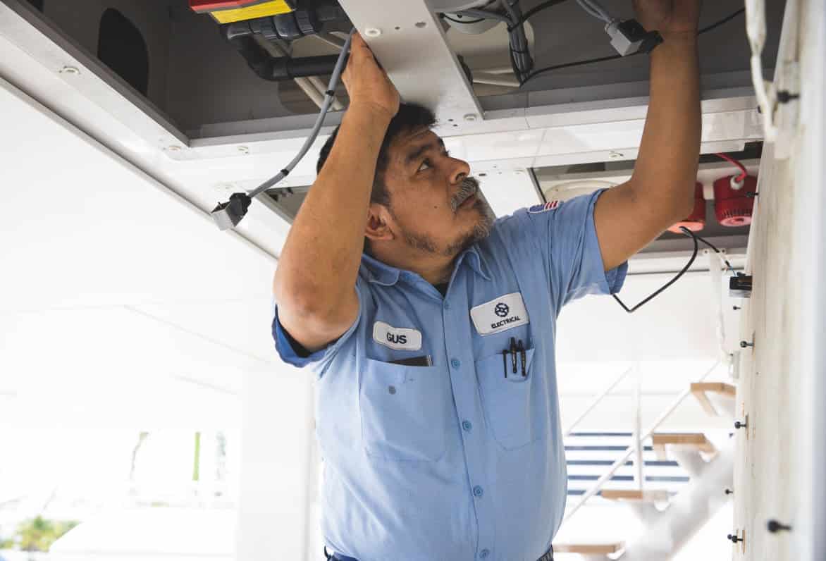 man working on electrical on a yacht