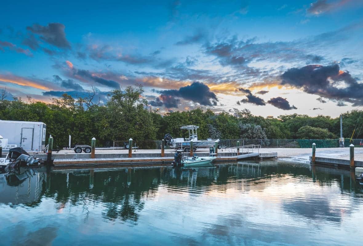 marina with one boat and clouds in the sky