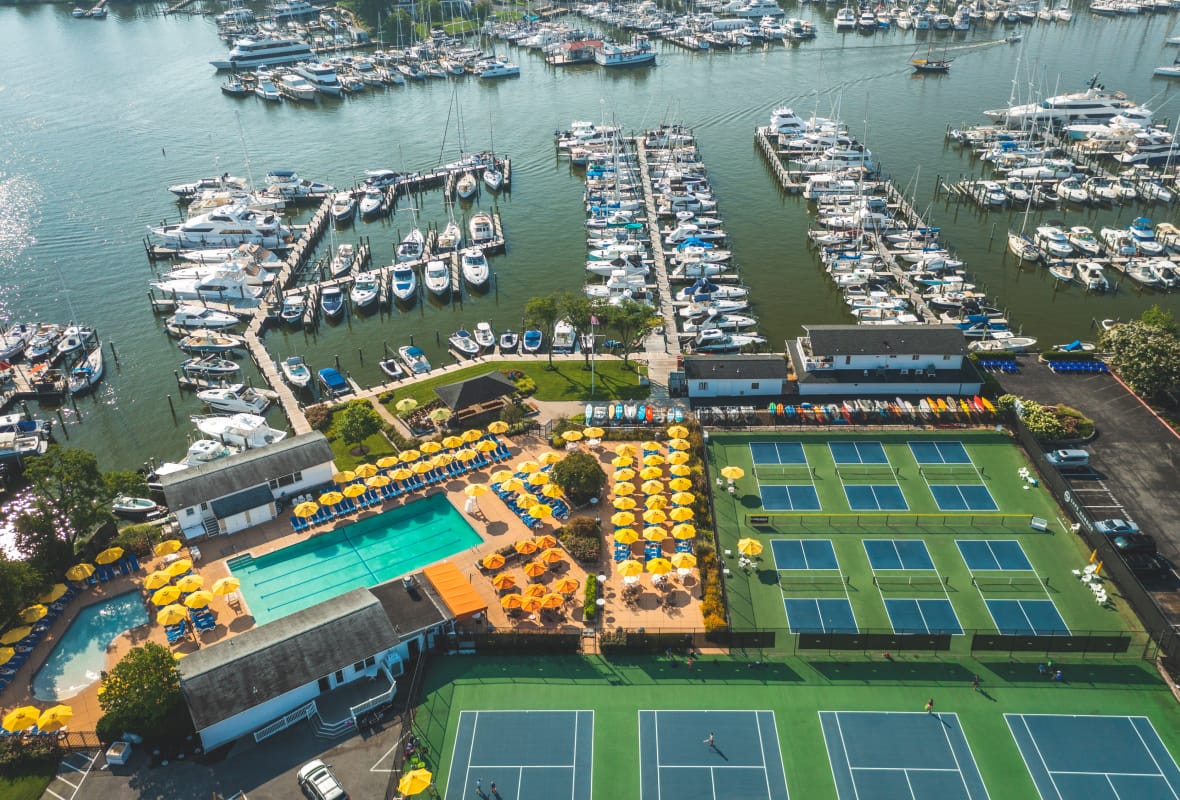 aerial view of marina, tennis courts, pickleball courts, and pool