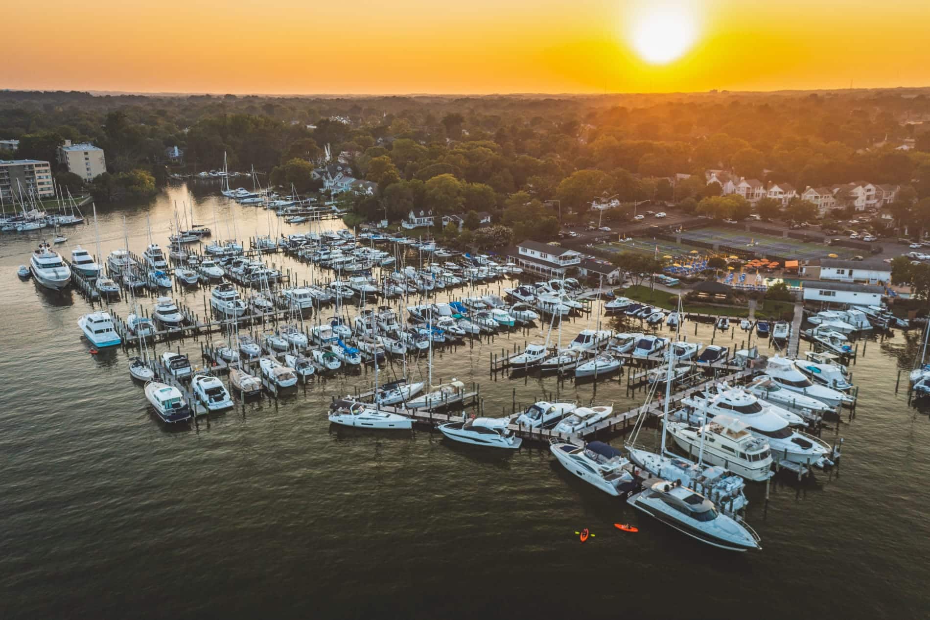 aerial view of a marina at sunset with many boats