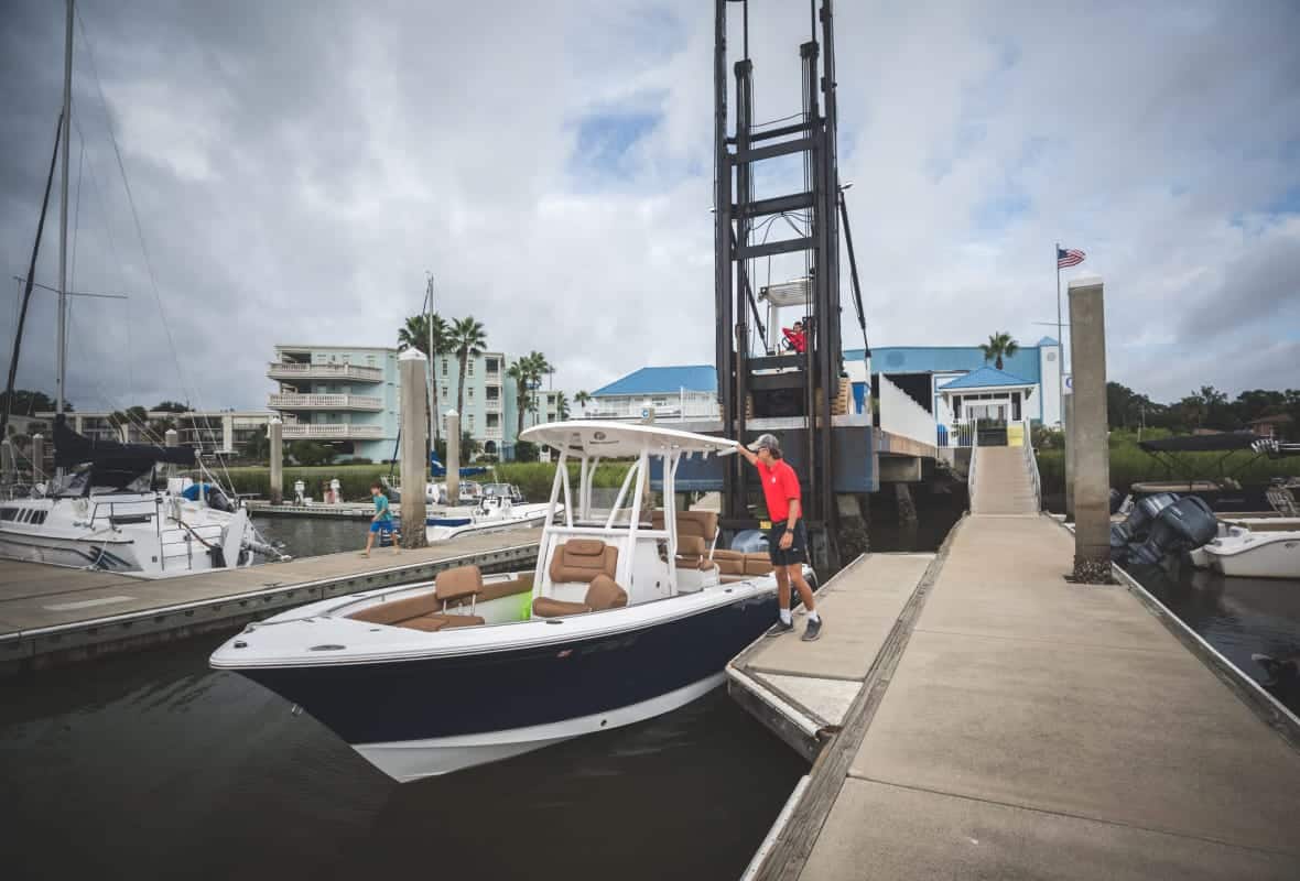 man holding onto a boat in a slip