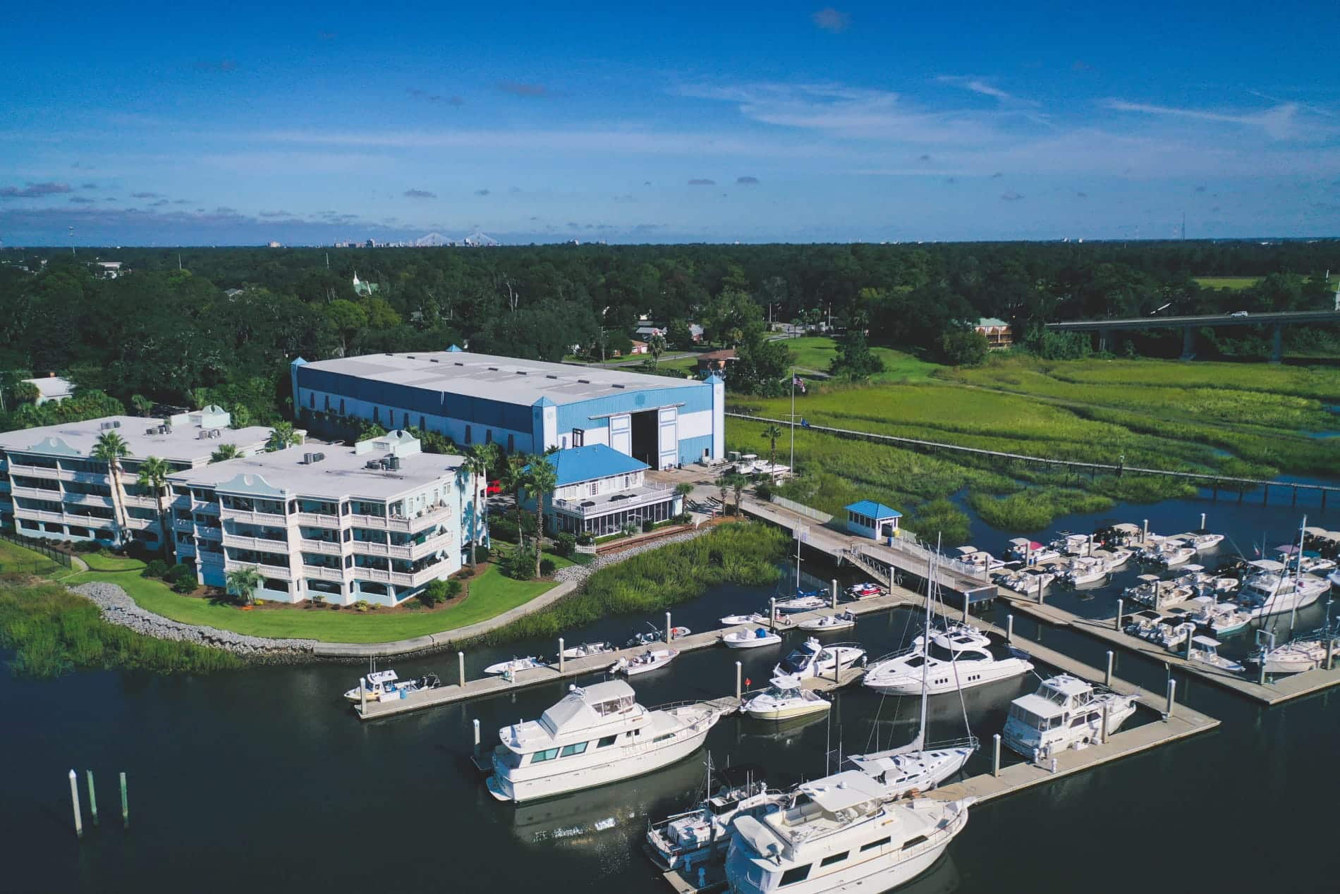boats in a marina with a blue and white large building
