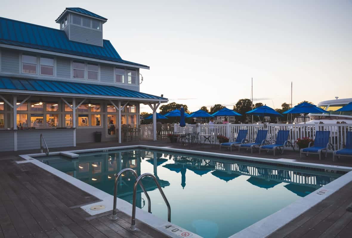 pool with chairs around it at dusk