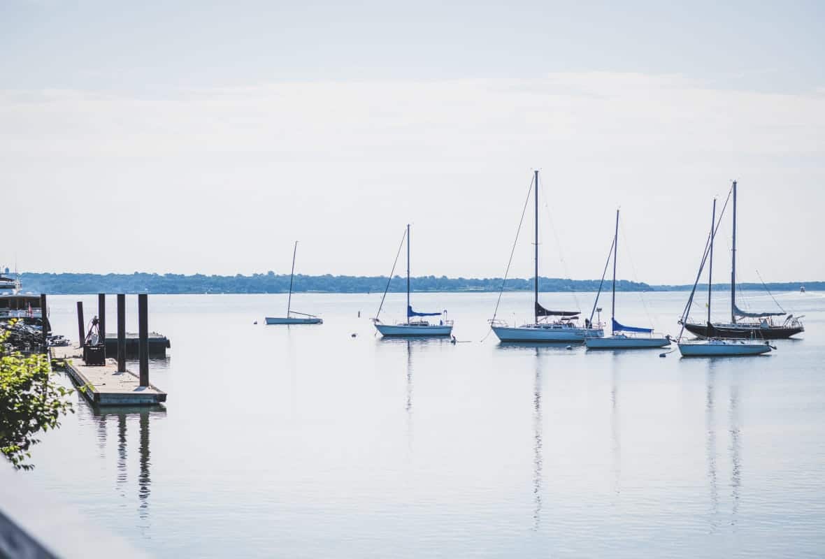 6 sailboats anchored in a bay