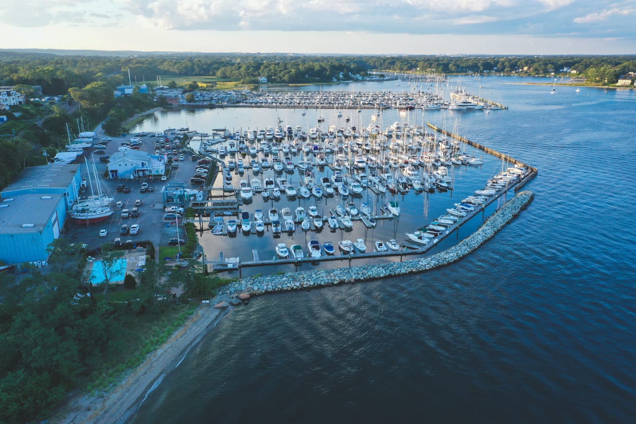 Drone shot of marina with lot of boats lined in slips
