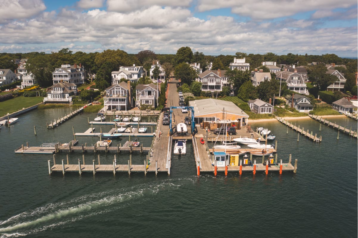 Aerial view of marina with lots of large houses surrounding it.
