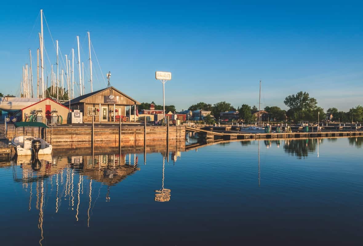 small wood building on calm water