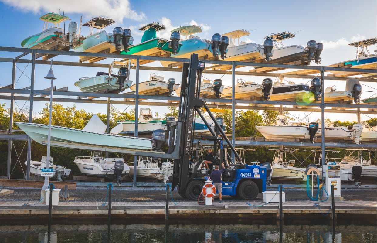 Boat in the process of being hoisted into an open-air storage