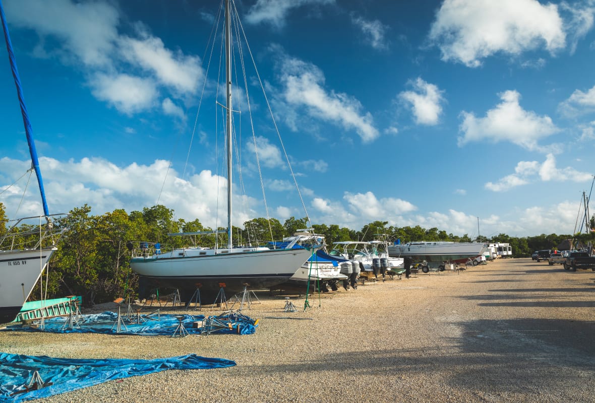 boats stored on dry land on gravel road