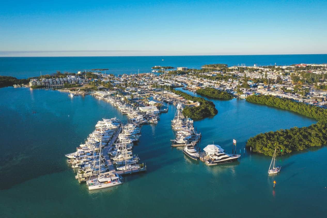 boats docked at marina on very blue water on sunny day