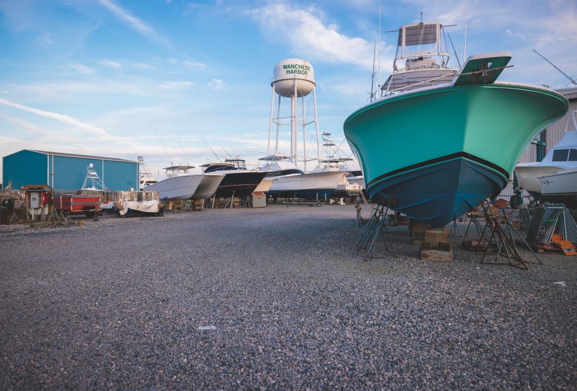 boats being stored with water tower in distance